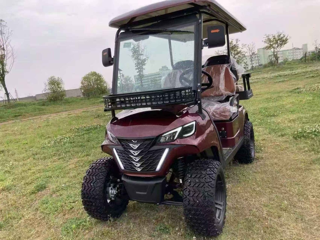 Wine red 2-seat on turf, front view